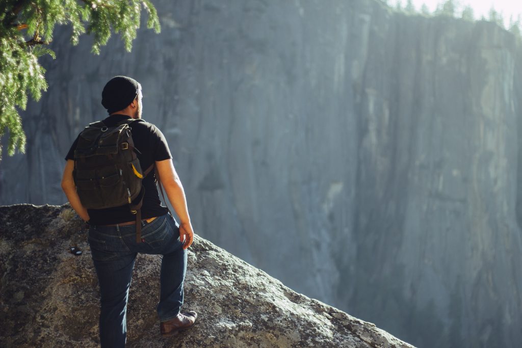 Person looking from top hill view best travel job
