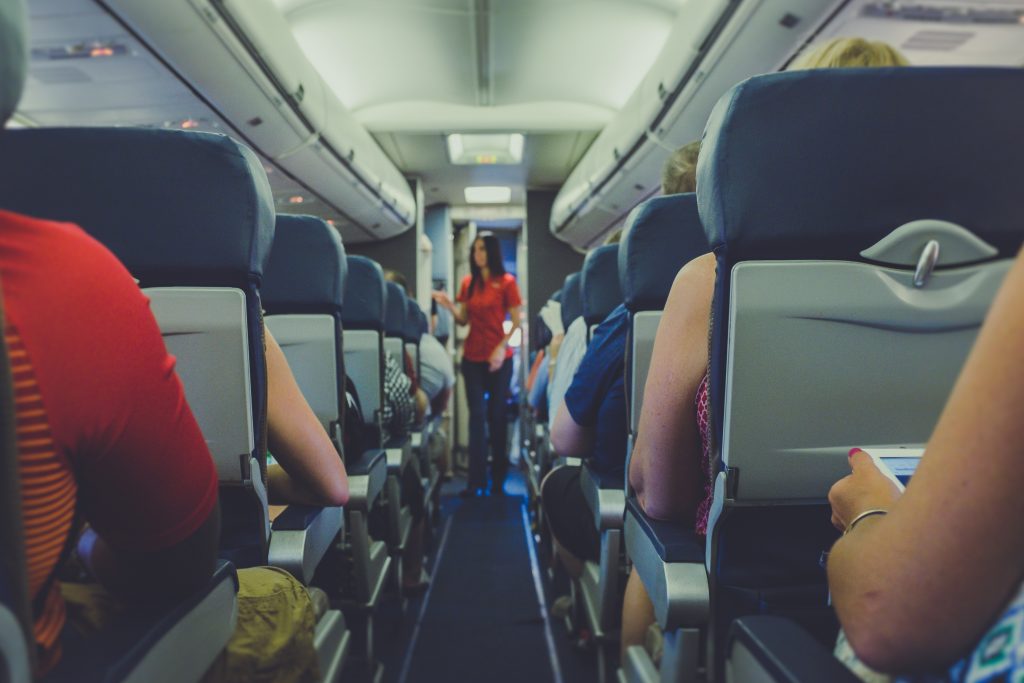 Flight attendant serving to passengers a travel job